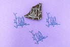 Hand carved owl wood block stamp printing a repeating owl pattern on paper or fabric