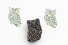 Hand carved wooden owl stamp with intricate decorative details printed in green ink on white paper