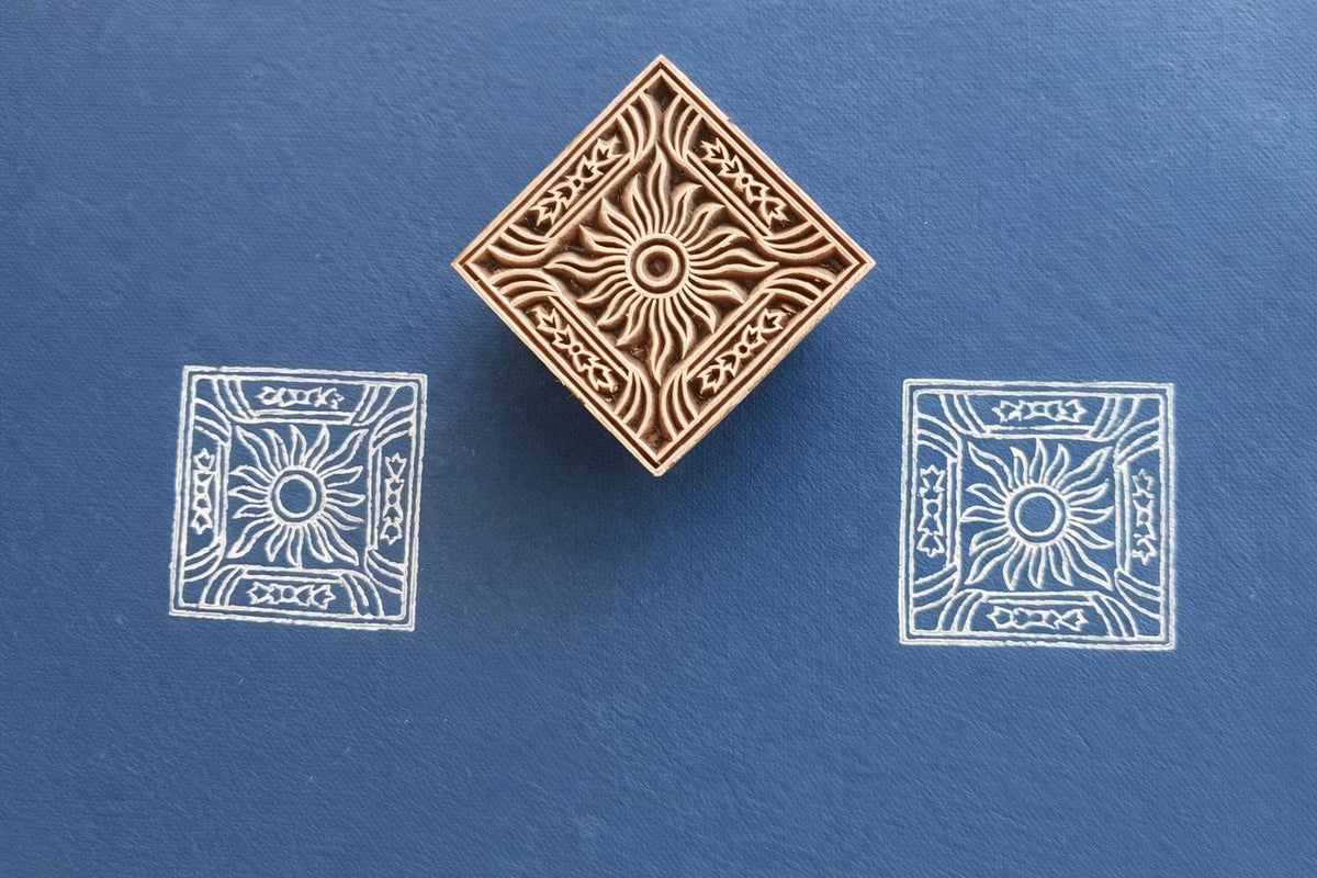 Hand carved wooden square stamp printing sun motif with decorative border