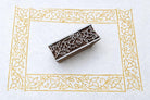 Hand carved wooden stamp printing floral vine border pattern with flowers and leaves