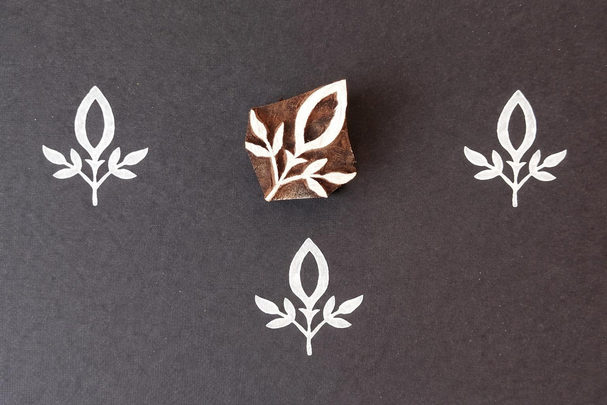 Wooden block stamp with simple leaf sprig design for fabric printing