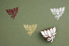 Hand stamped grand lotus design in red white and gold ink on green paper
