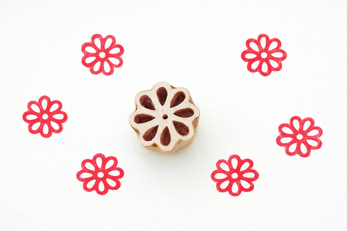 Hand carved wooden stamp with rounded petal flower and center dot