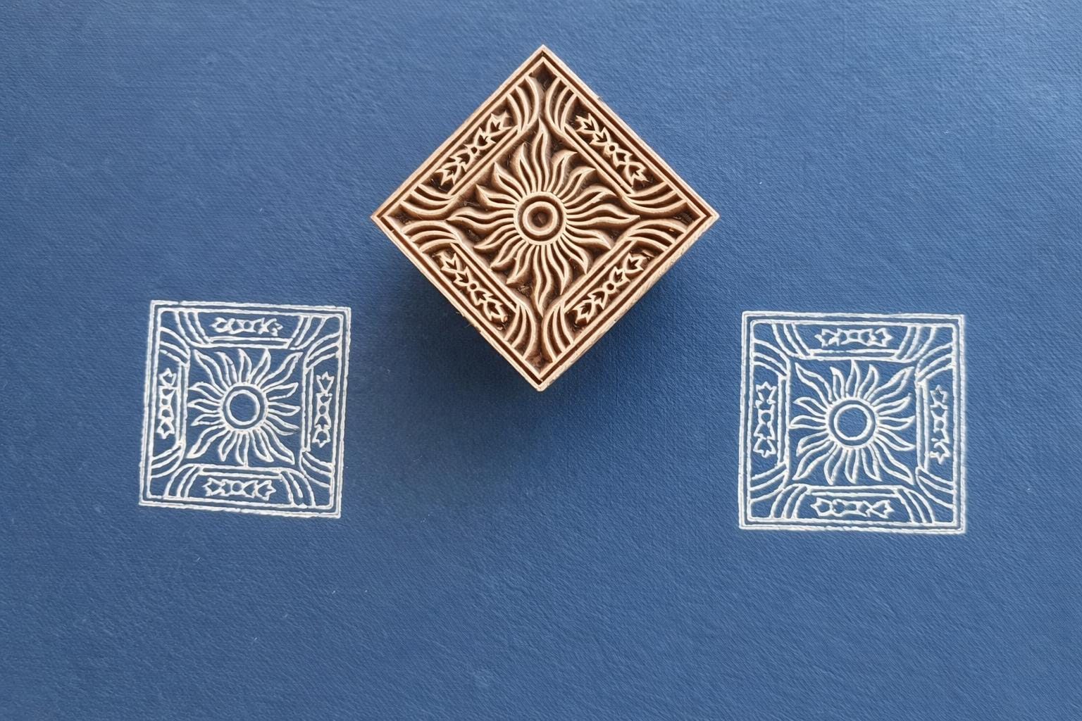 Hand carved wooden square stamp printing sun motif with decorative border