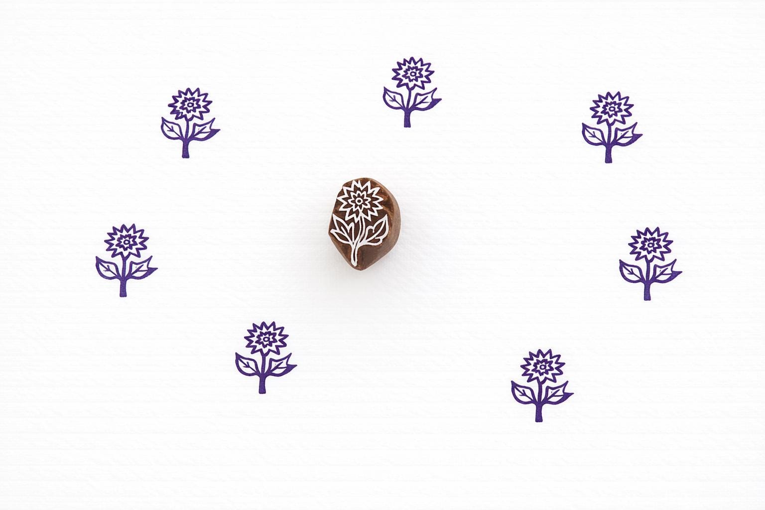 Hand carved wooden stamp printing simple daisy flower with stem and leaves