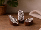 Set of three handmade wooden mini block print stamps with fern leaf, branch, and fan palm patterns