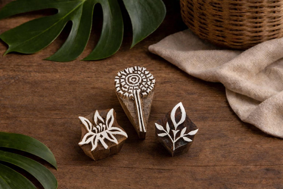 Set of three hand carved wooden printing stamps featuring floral and leaf designs for fabric and paper block printing