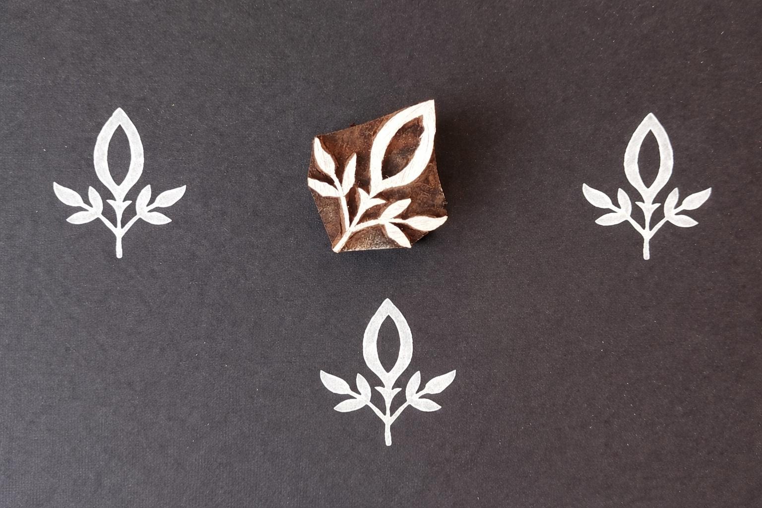 Wooden block stamp with simple leaf sprig design for fabric printing