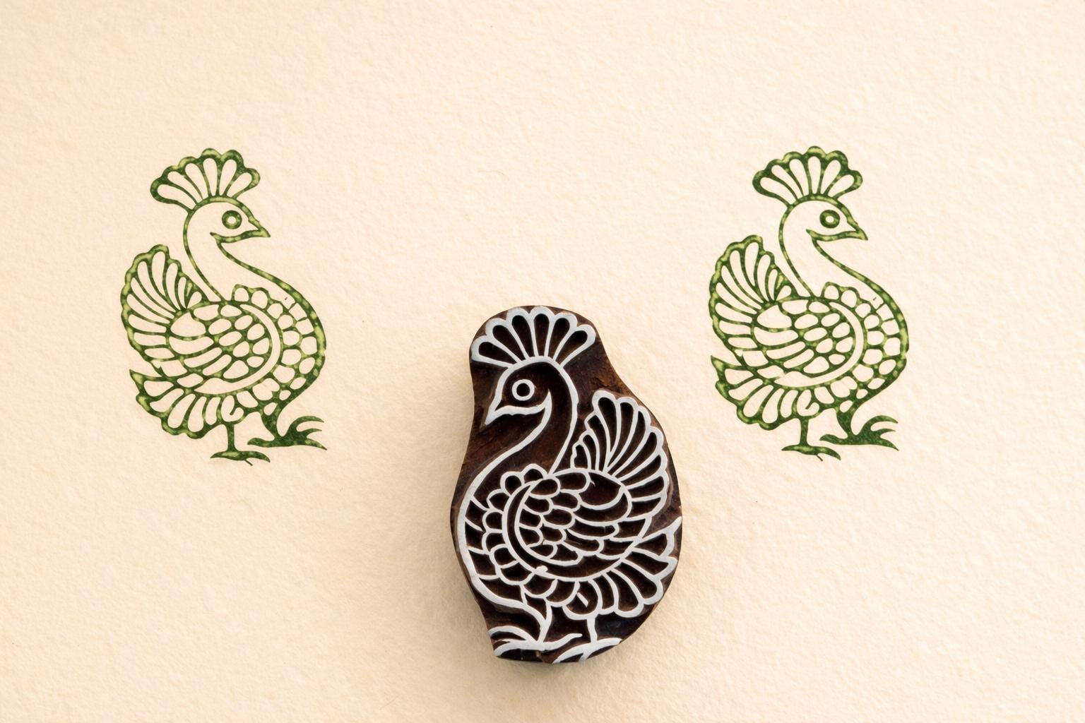 Peacock wooden textile stamp used on fabric showing green block print design Indian printing block