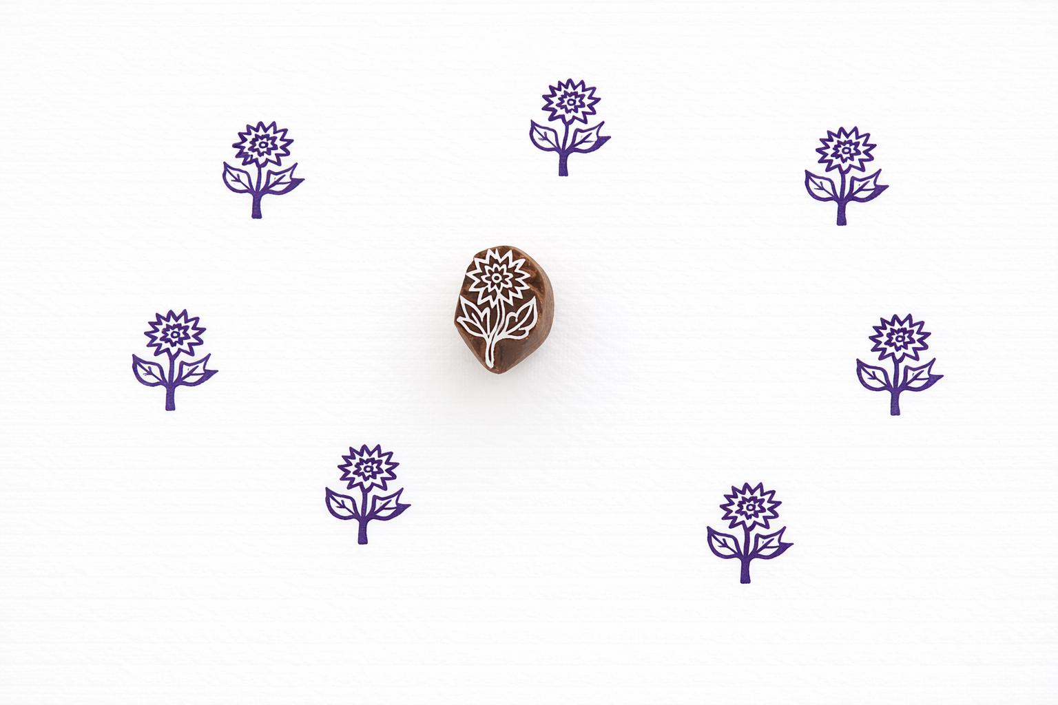 Hand carved daisy flower stamp used for block printing on paper