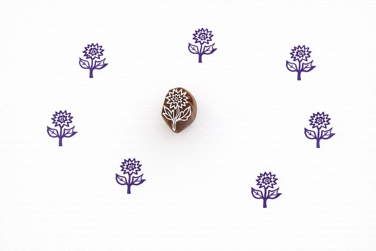Hand carved daisy flower stamp used for block printing on paper