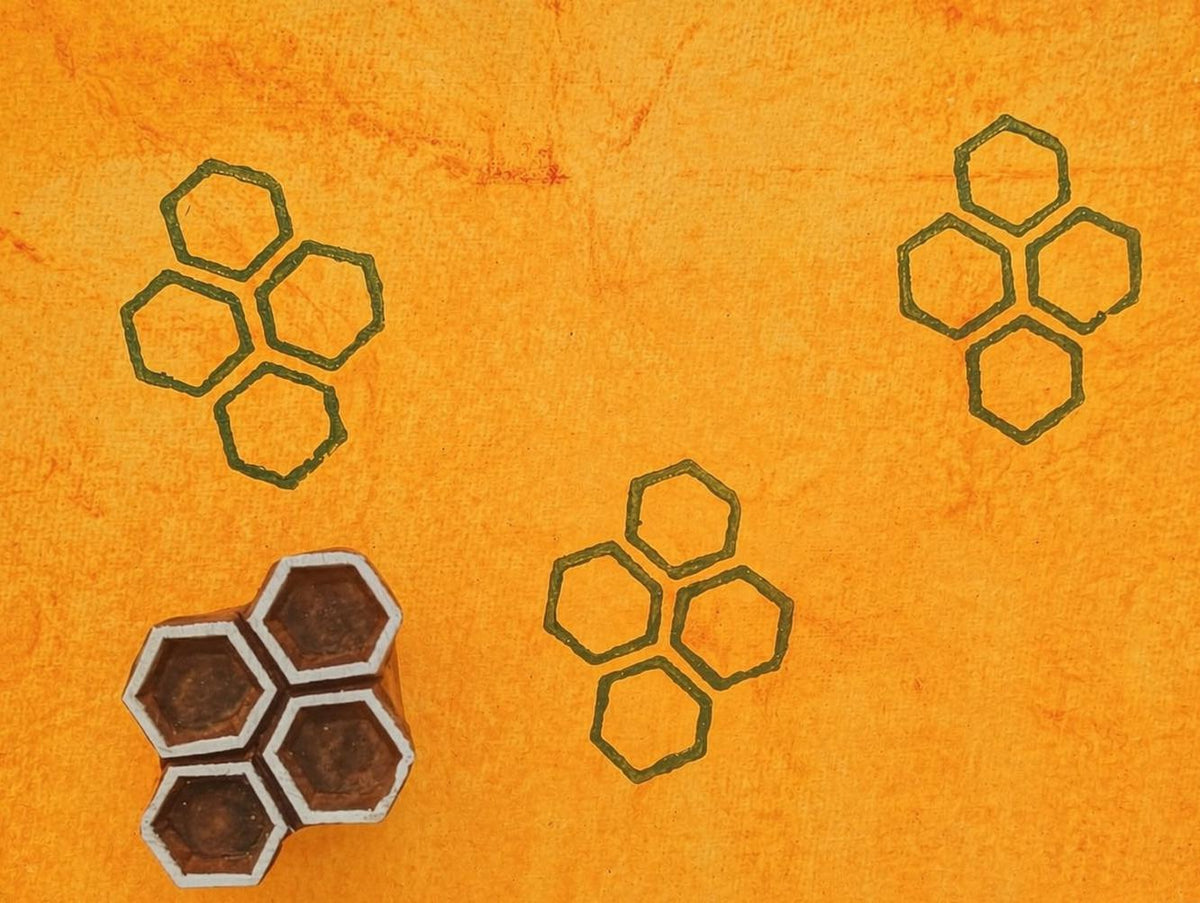 Honeycomb hexagon pattern printed with handmade wood stamp in ink on textured paper