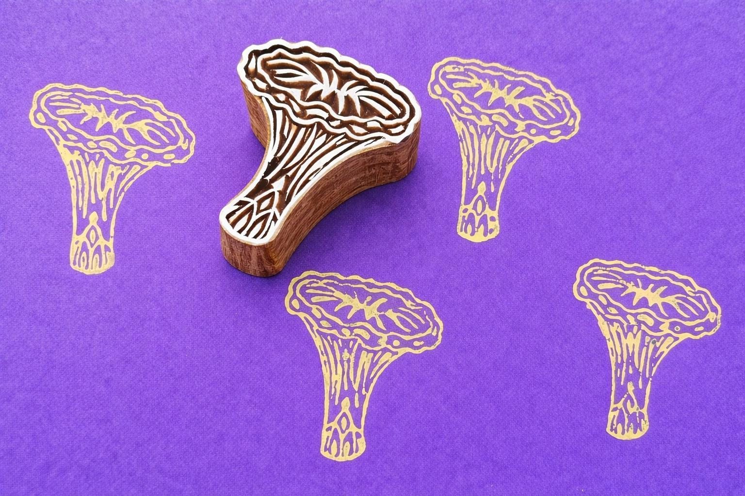 Chanterelle mushroom wood block stamp creating repeating print pattern