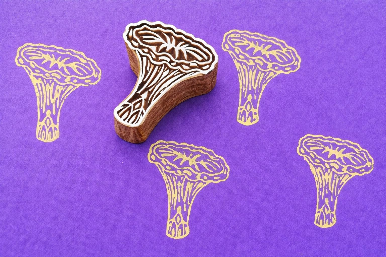 Chanterelle mushroom wood block stamp creating repeating print pattern