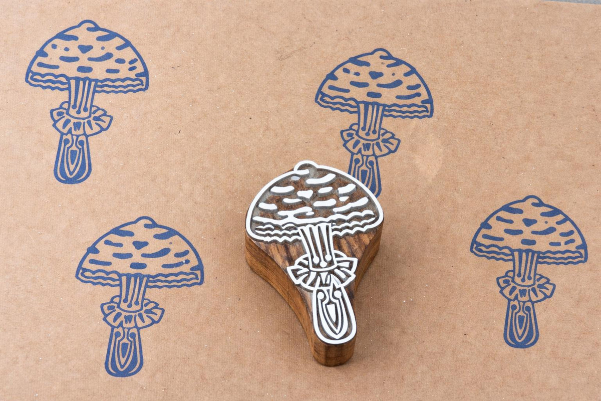 Forest mushroom block print pattern on kraft paper using hand carved stamp