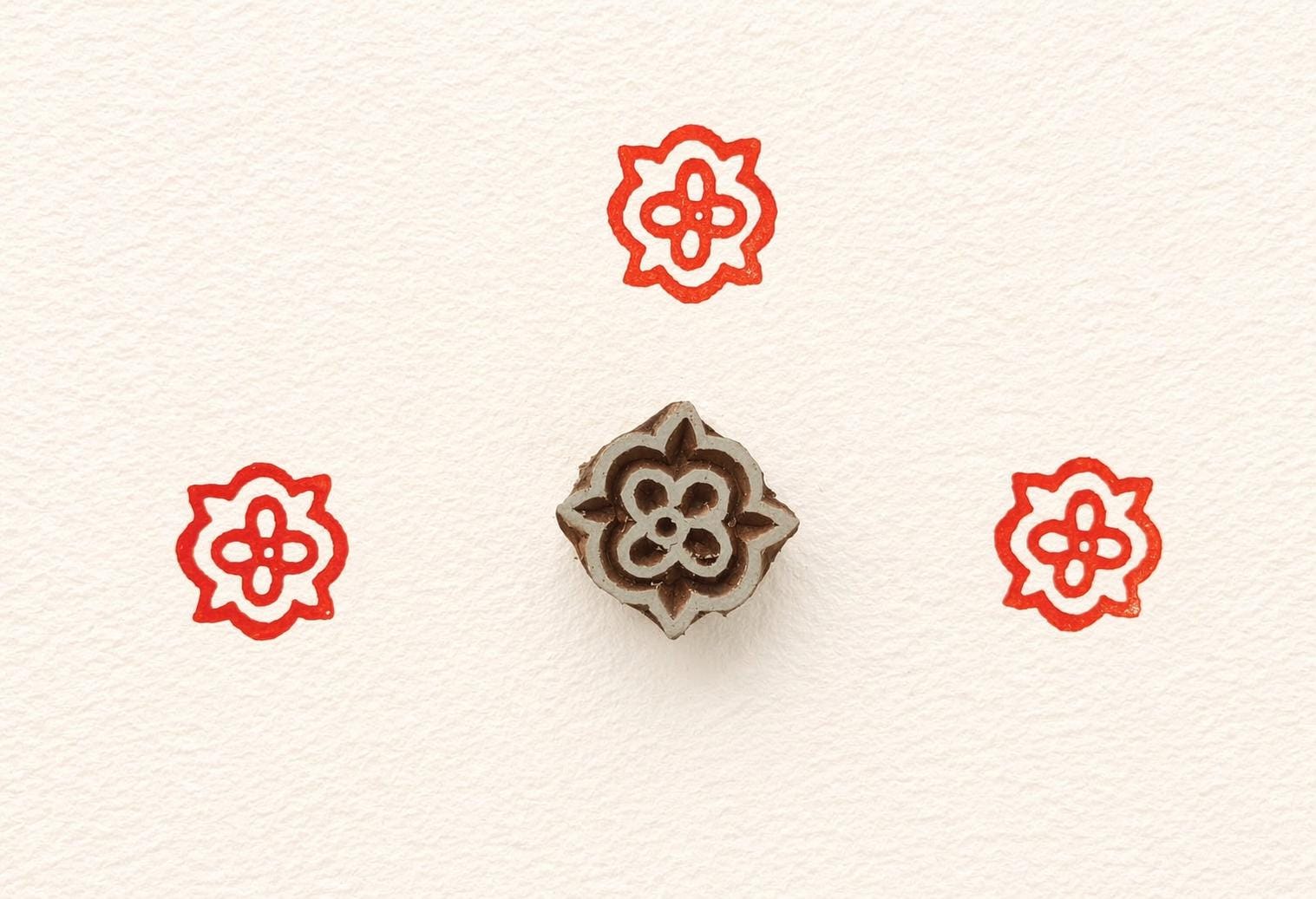 Small hand carved wooden printing stamp with floral design for fabric printing, textile patterns, and clay pottery