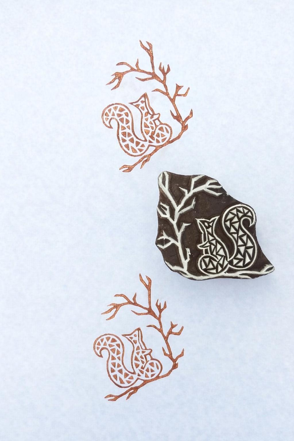 Hand carved wooden printing stamp with squirrel on branch design for fabric printing, woodland patterns, and clay pottery