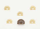 Hand carved wooden block stamp creating a minimalist boho sunrise pattern with radiating lines on neutral background