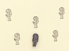 Hand carved wooden printing block making botanical pattern on paper