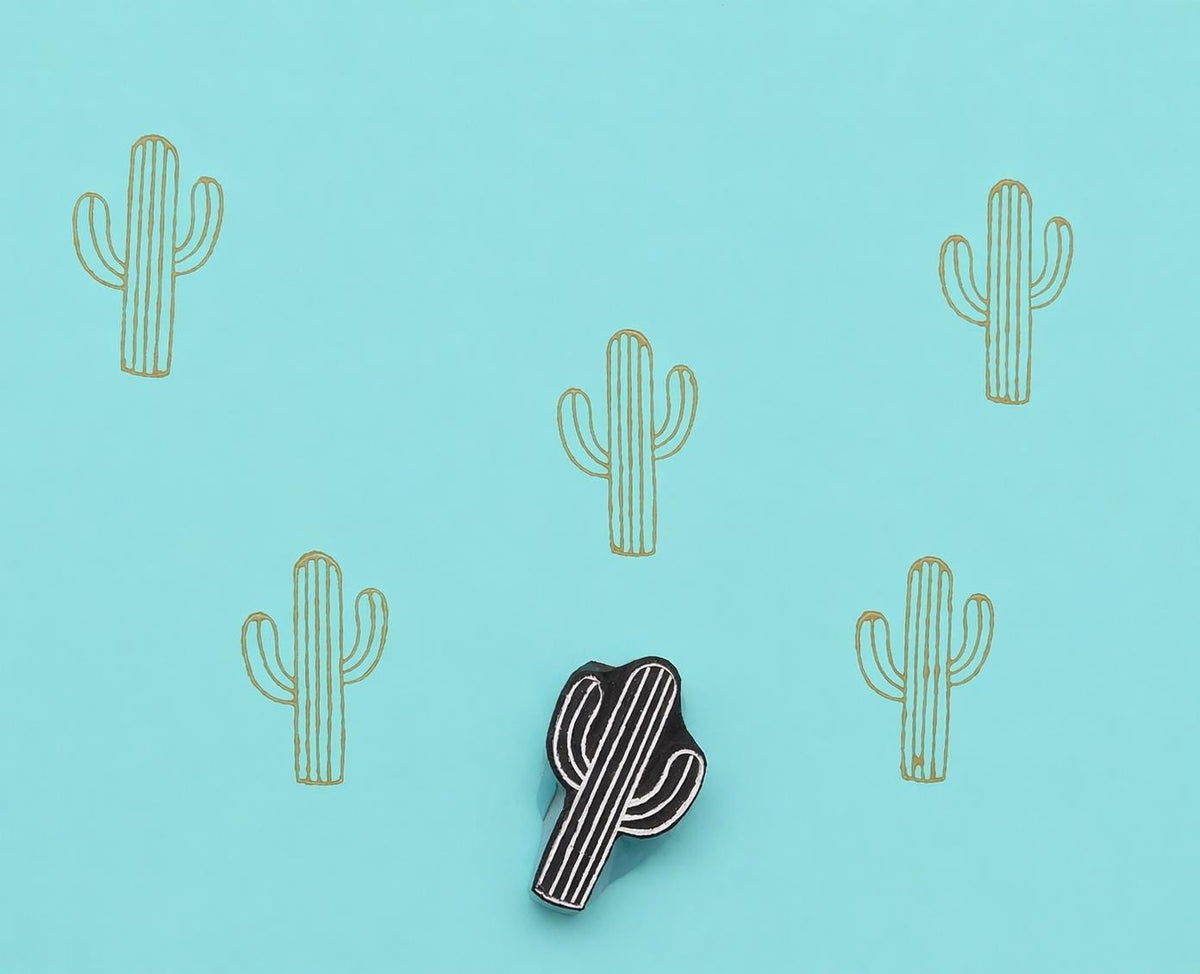 Cactus wooden printing block creating repeating pattern on fabric