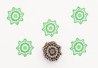 Hand carved wooden printing block with an ornamental radial pattern inspired by henna style symmetry for textile and surface design.
