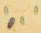 Prickly pear cactus stamp making green repeating pattern on handmade paper