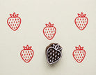 Hand carved wooden printing block with a simple strawberry illustration for fabric printing, paper crafts, and repeat fruit patterns.