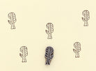 Hand carved wooden printing block making botanical pattern on paper