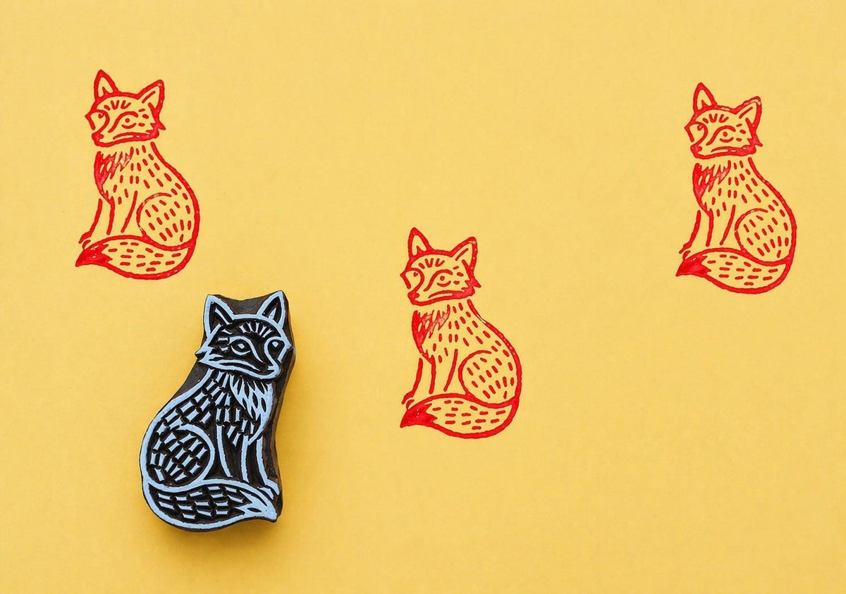 Sentinel Fox wood block stamp with red ink prints on yellow background
