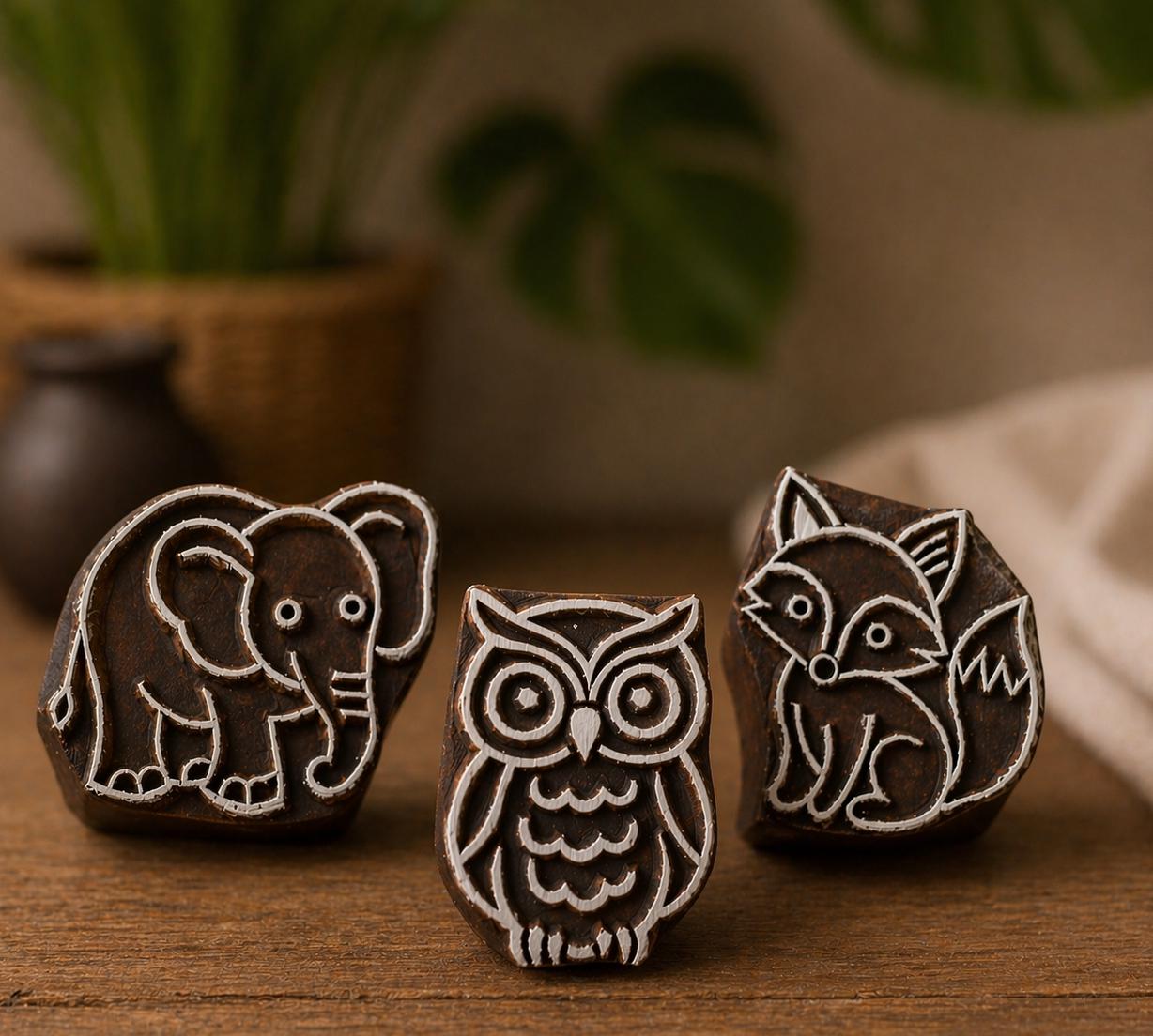 Hand carved wooden animal printing stamp set including fox owl and elephant blocks with sample prints, woodland and safari themed textile printing tools