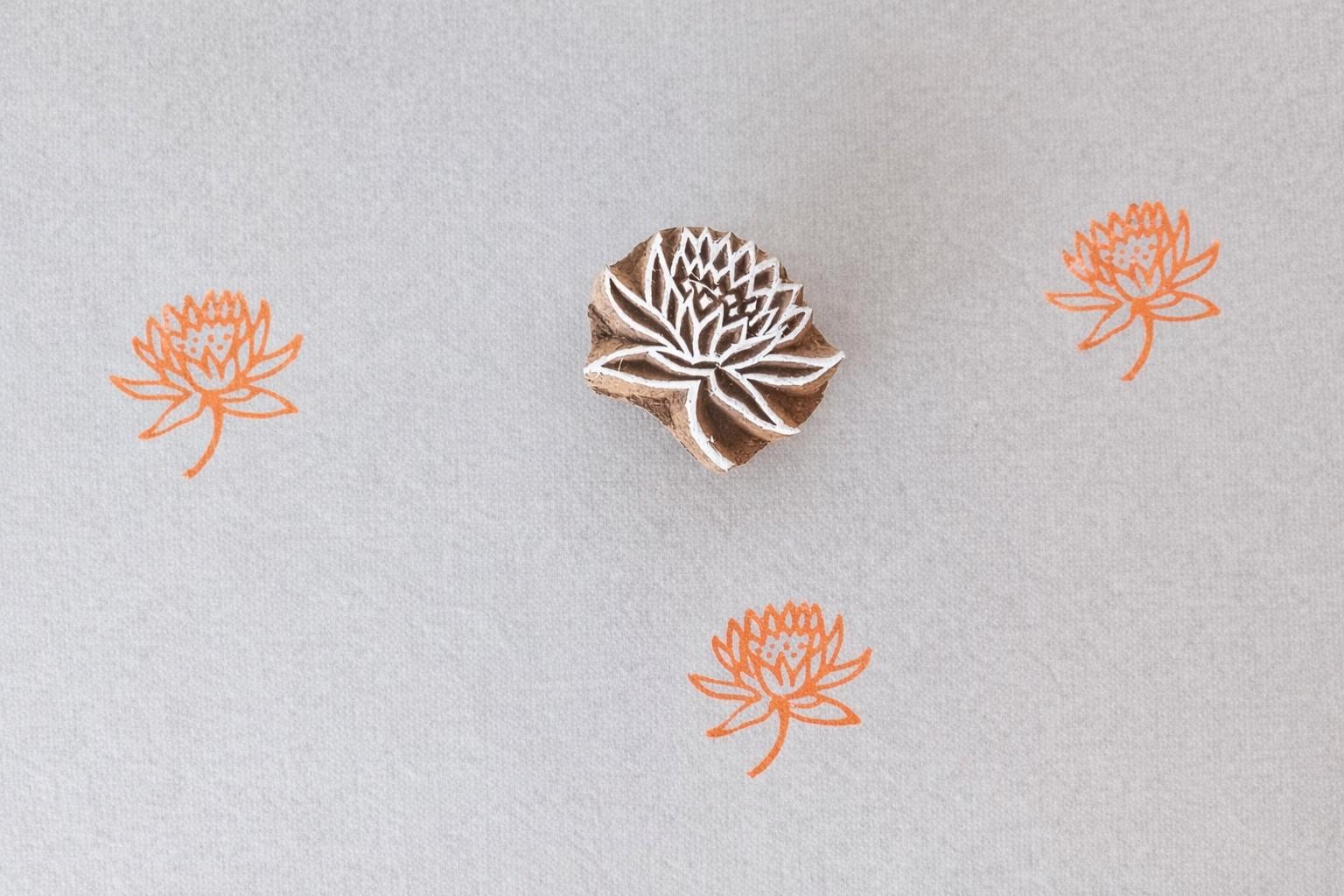 Hand carved lotus mini stamp printing orange floral pattern on fabric