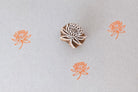 Hand carved lotus mini stamp printing orange floral pattern on fabric