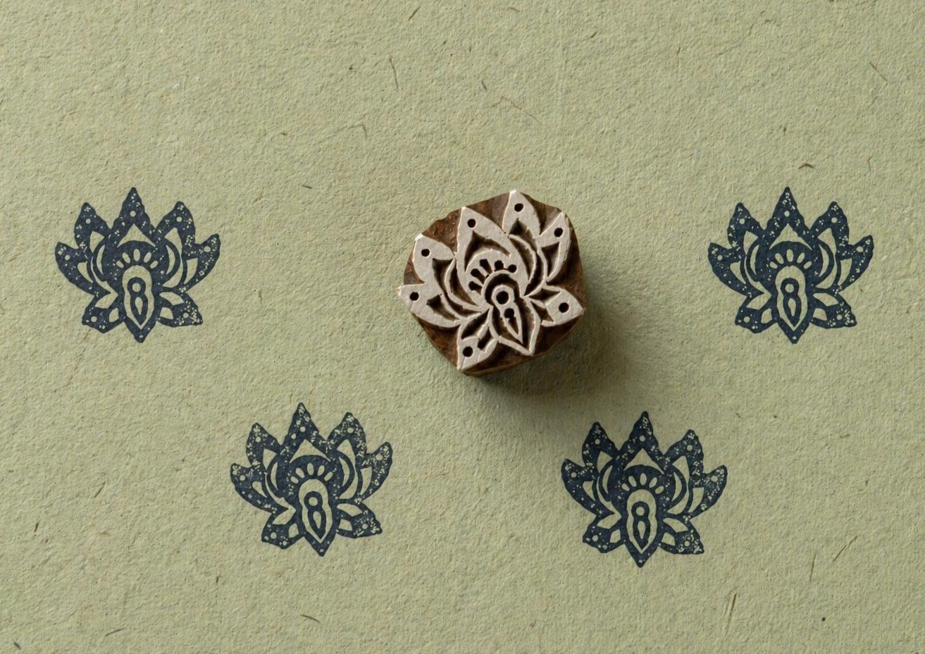 Black small lotus flower block print pattern on paper using wooden stamp