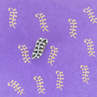 Hand carved Indian wooden printing block featuring small vine motif creating repeating yellow filler pattern on purple fabric