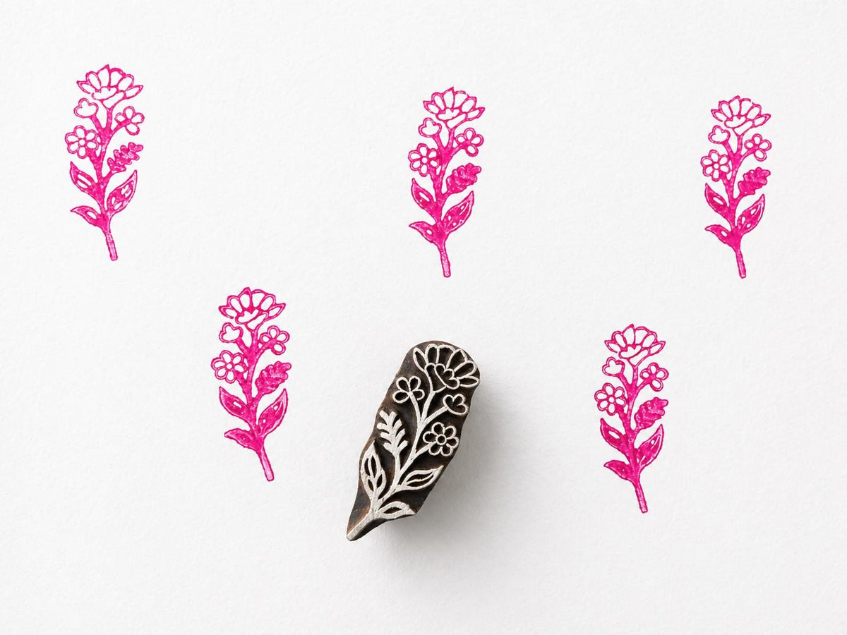 Hand carved wooden printing block with a decorative posy bloom motif for botanical textile printing and handmade surface pattern crafts.