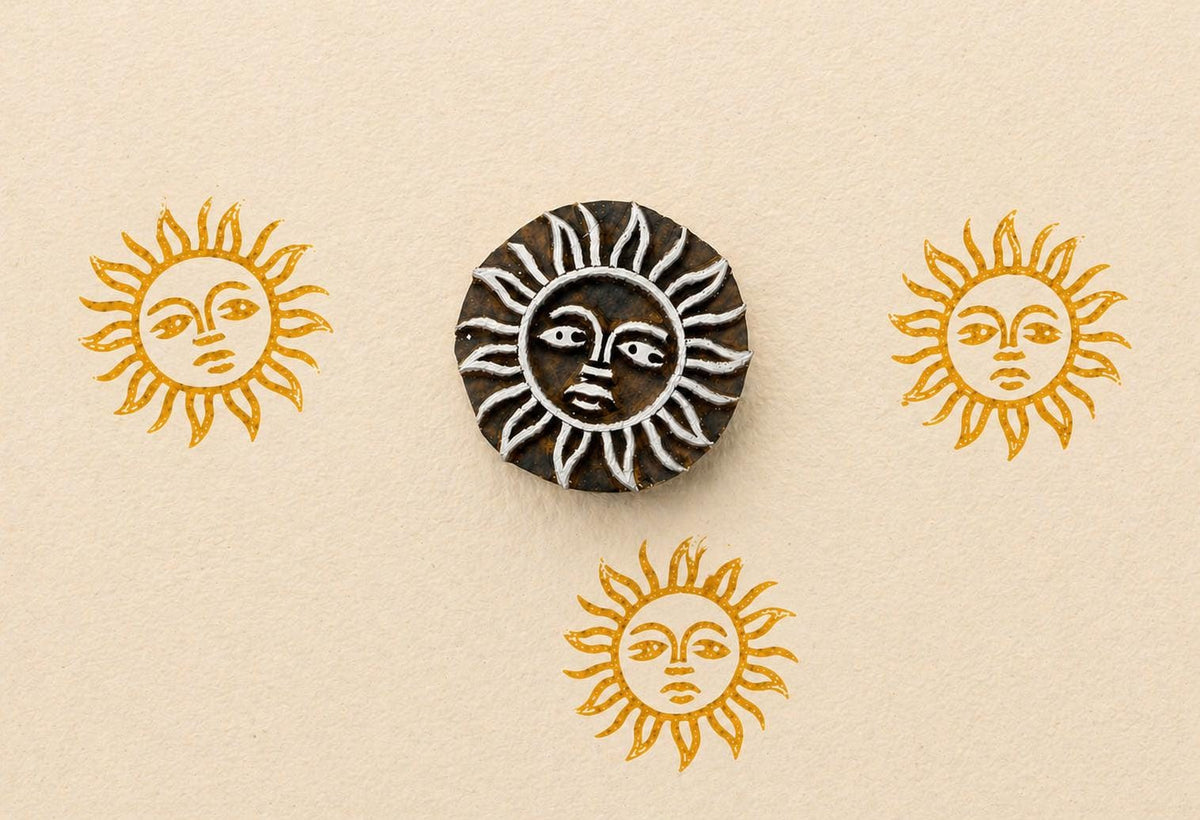 Sun face wooden stamp creating repeated golden sun prints on neutral paper
