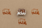Hand carved wooden auto rickshaw block stamp printing tiny tuk tuk vehicle motif in brown ink on kraft paper