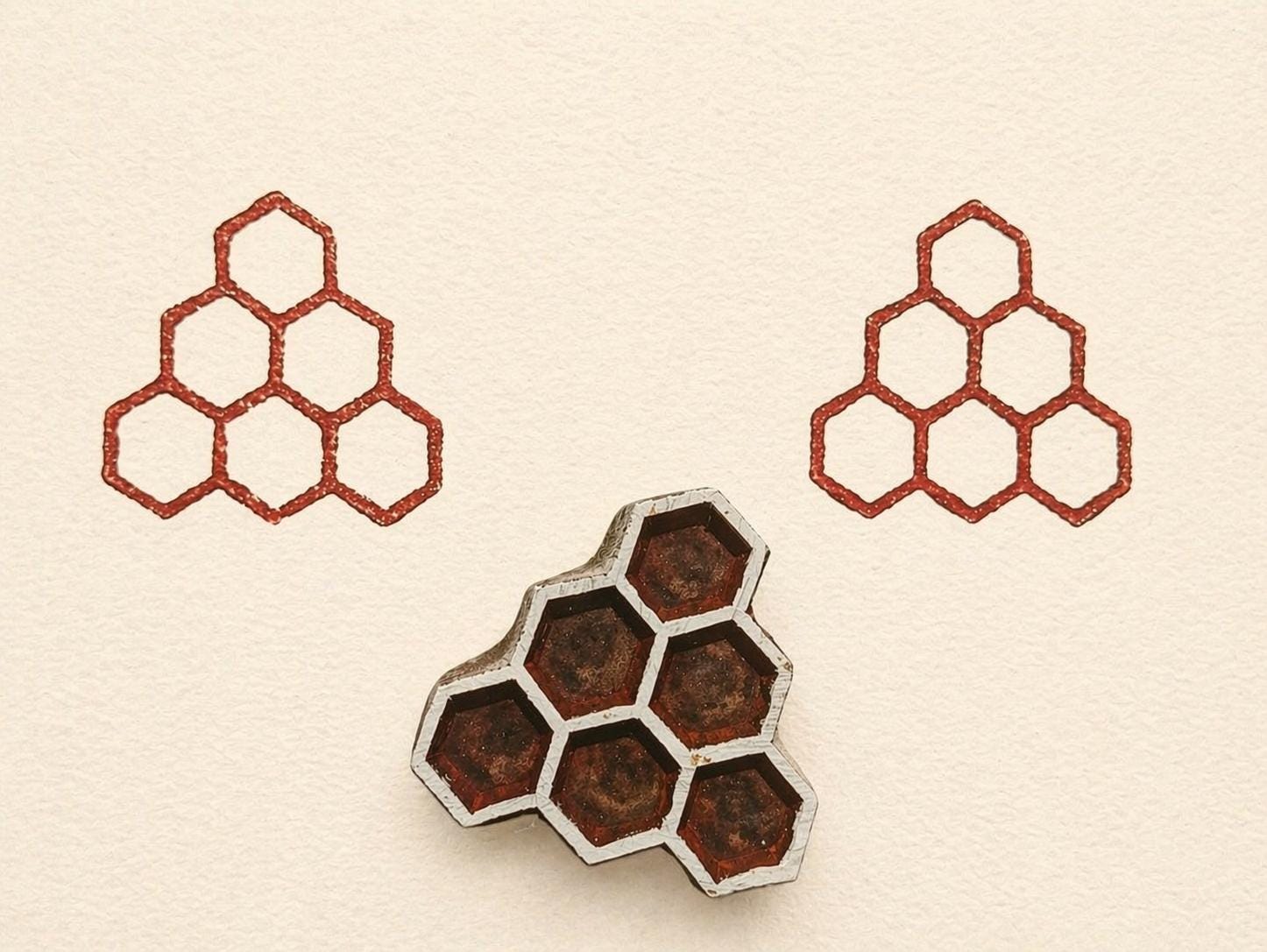 Wooden block print stamp with geometric hexagon cluster creating a clean honeycomb pattern on neutral background