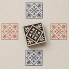 Hand carved Indian wooden block featuring heritage tile motif printed in blue and terracotta on textured cream background for textile printing, pottery, clay, and paper crafts.