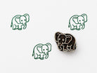 Hand carved wooden printing block with a cute elephant illustration creating repeating animal patterns on fabric, paper, or clay.