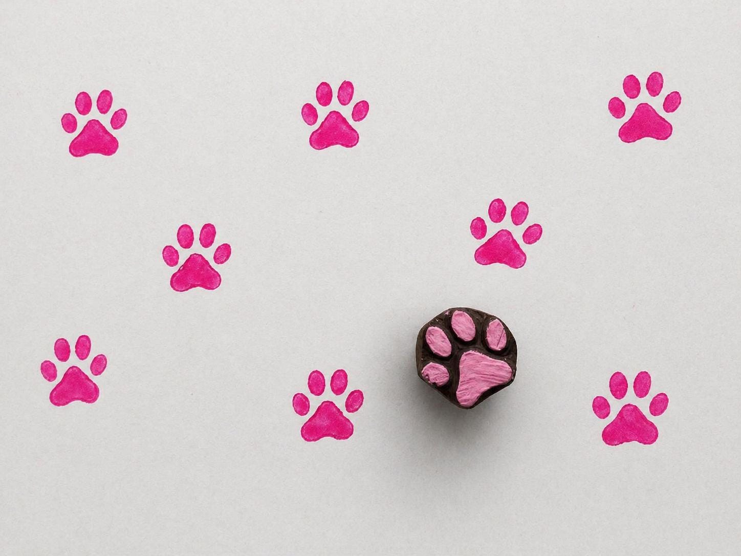Hand carved paw print wooden block for pet themed fabric printing, pottery decoration, and clay impressions.
