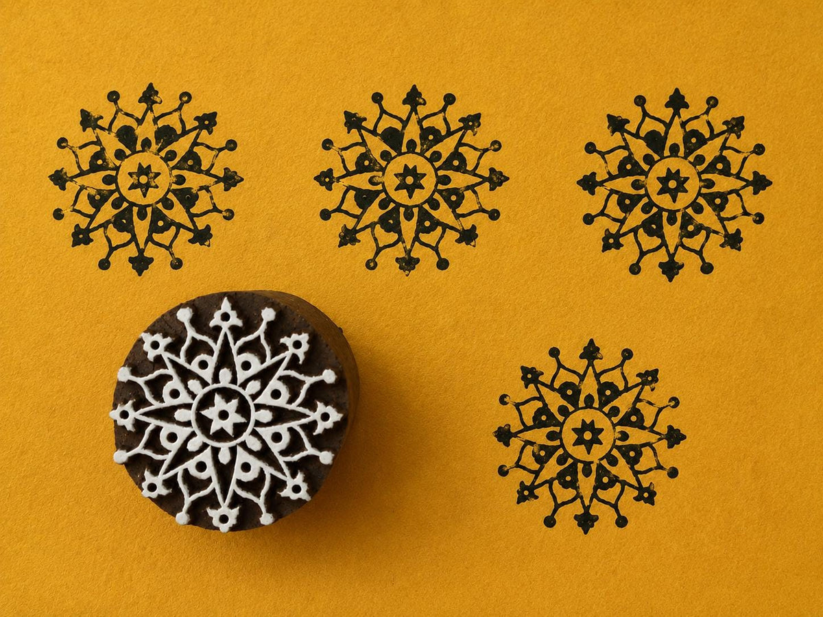 Hand carved Indian wooden block featuring an intricate celestial mandala pattern printed in black on golden yellow background for textile printing, pottery, clay, and paper crafts.