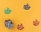 Hand carved wooden printing block with a layered folk leaf motif for textile printing, paper crafts, and botanical surface patterns.
