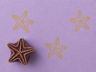 Hand carved Indian wooden block featuring coastal sea star motif printed in mustard yellow on lavender background for textile printing, pottery, clay, and paper crafts.