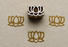 Hand carved Temple Lotus wooden block stamp with metallic gold lotus impressions on textured handmade paper.