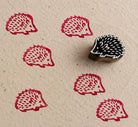 Hand carved hedgehog textile stamp printing red woodland animal impressions on handmade paper