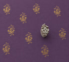 Hand carved Ornamental Vine wooden block stamp with metallic gold impressions on deep purple handmade paper.
