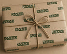 Hand carved wooden border printing block impressions on kraft paper box which is gift wrapped