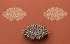 Hand carved Indian wooden printing block featuring an ornate radiant mandala motif stamped on terracotta handmade paper, suitable for fabric printing, pottery decoration, clay impressions, and decorative craft projects.