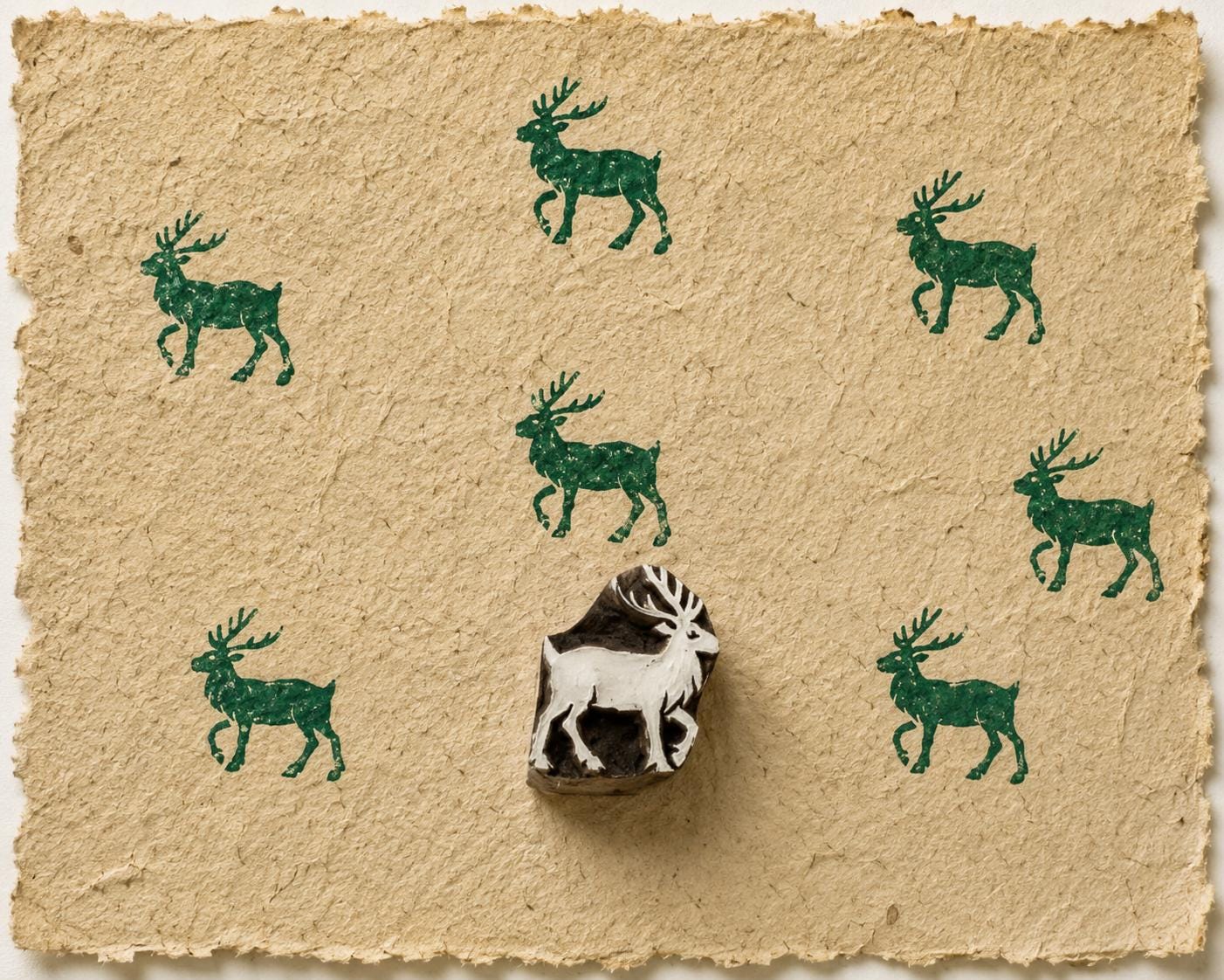 Hand carved Highland Deer wooden block stamp with forest green deer impressions on handmade natural fibre paper.